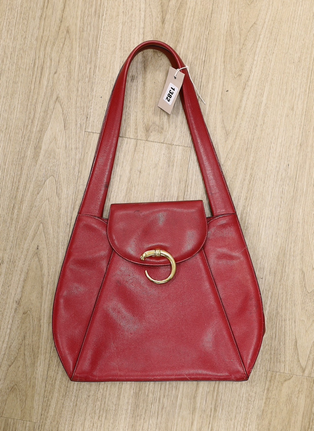 A red Cartier “Panther bag”, 54cms from the top of the handle to base of bag